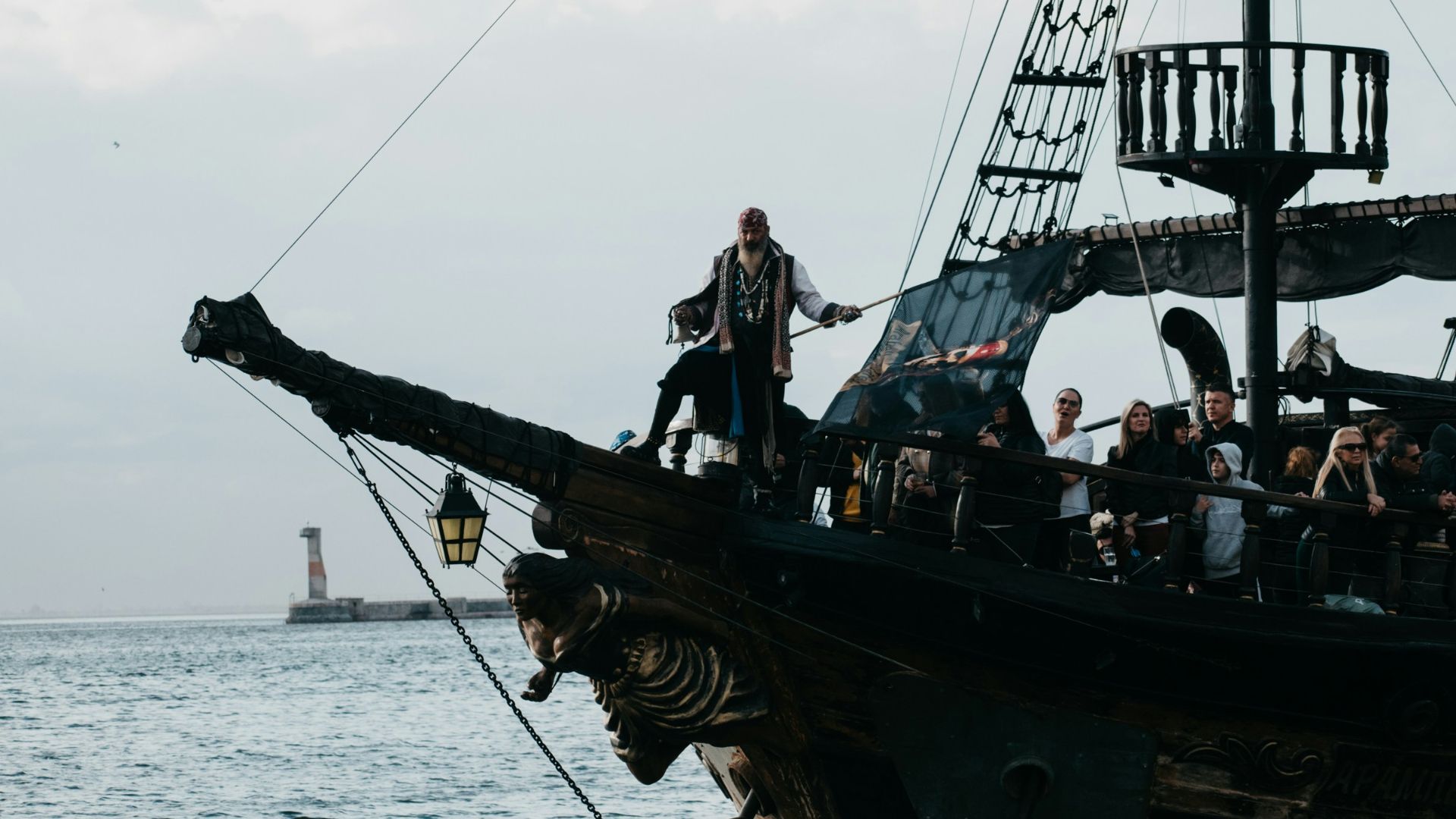 a group of people standing on top of a pirate ship