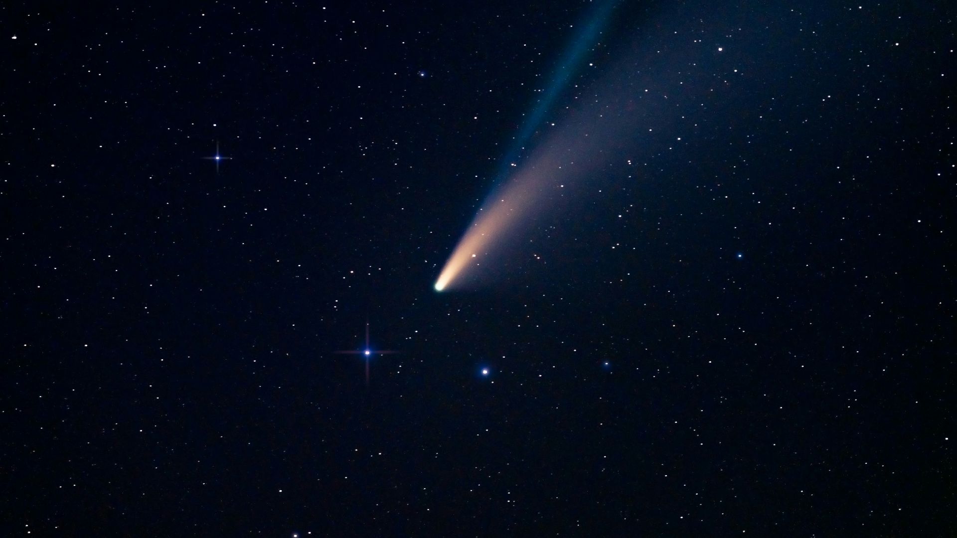 a comet is seen in the night sky
