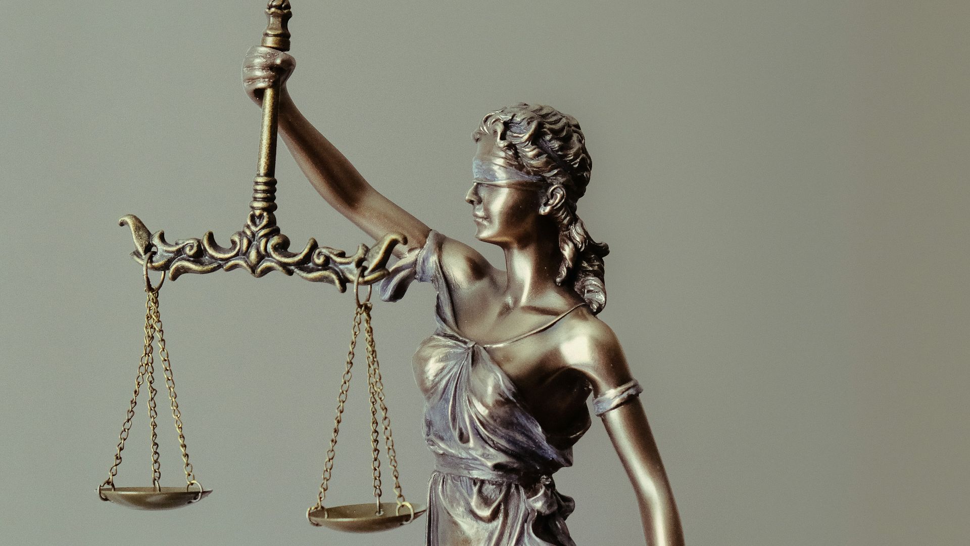 woman in gold dress holding sword figurine