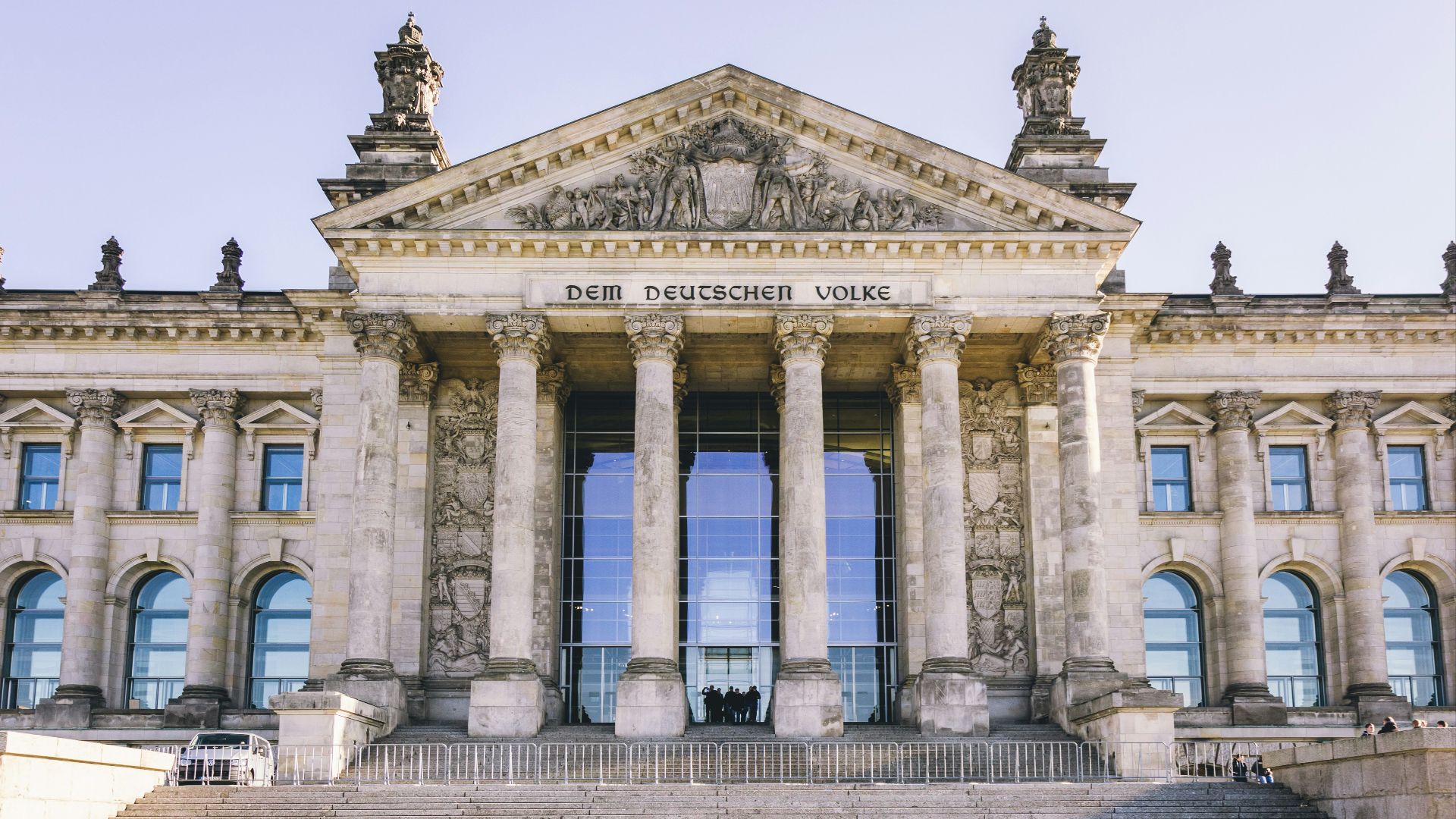 people walking in front of white concrete building during daytime