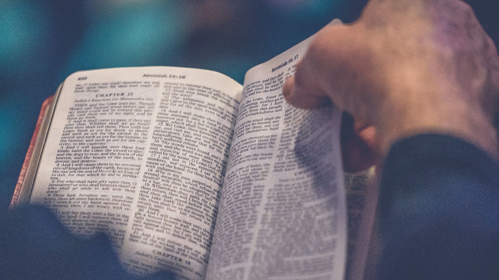 person's hand holding book page