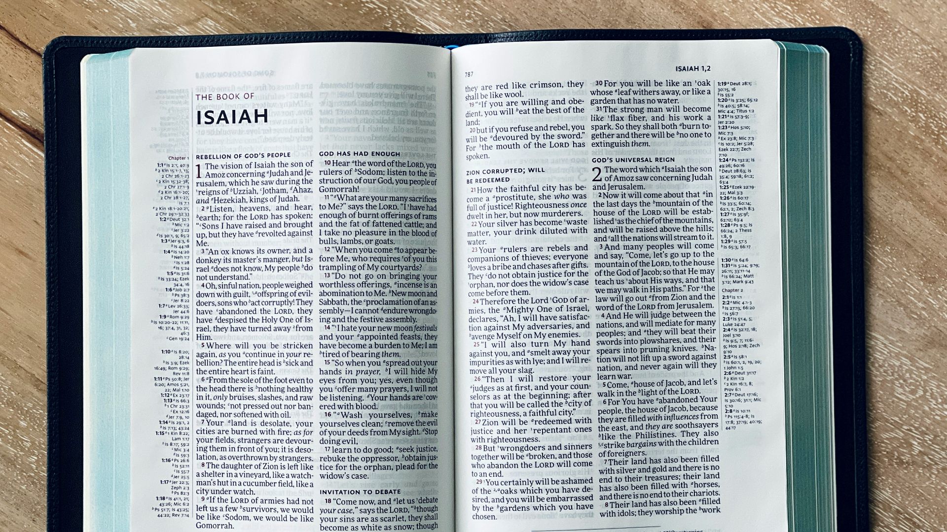 an open bible on a wooden table