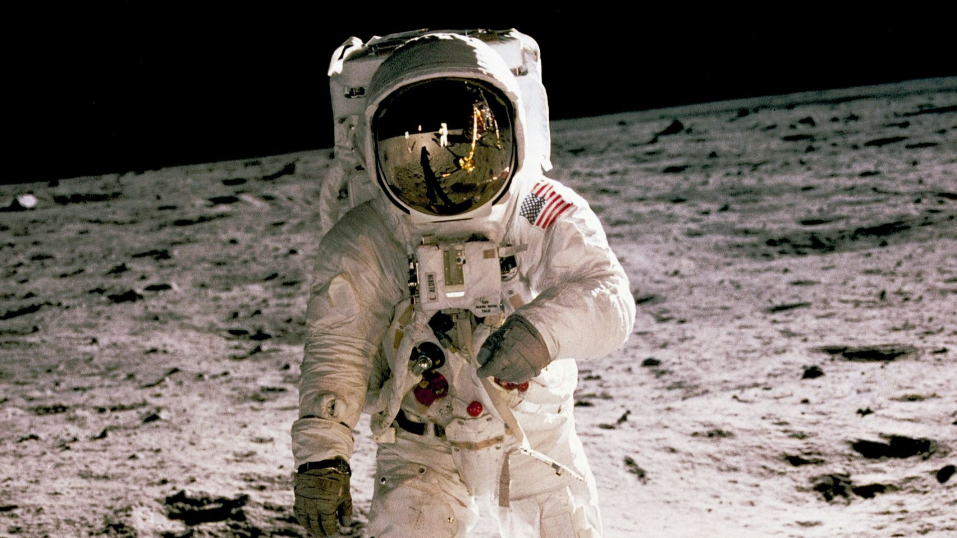 astronaut standing on gray sand