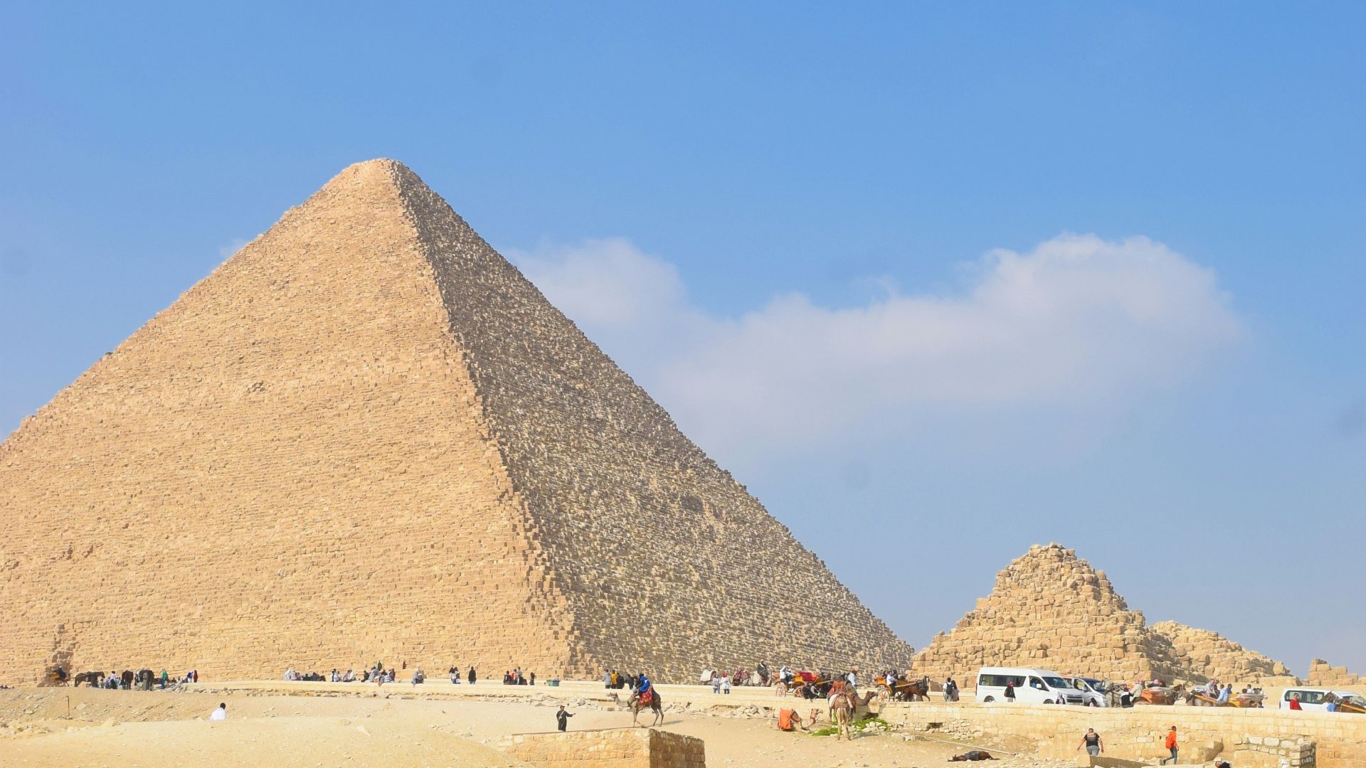 a group of people standing in front of a pyramid