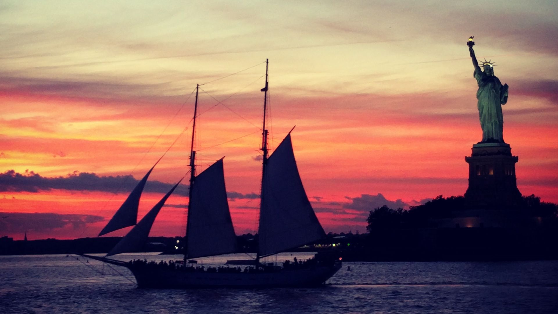 File:Statue of Liberty and sailboat at sunset.jpg