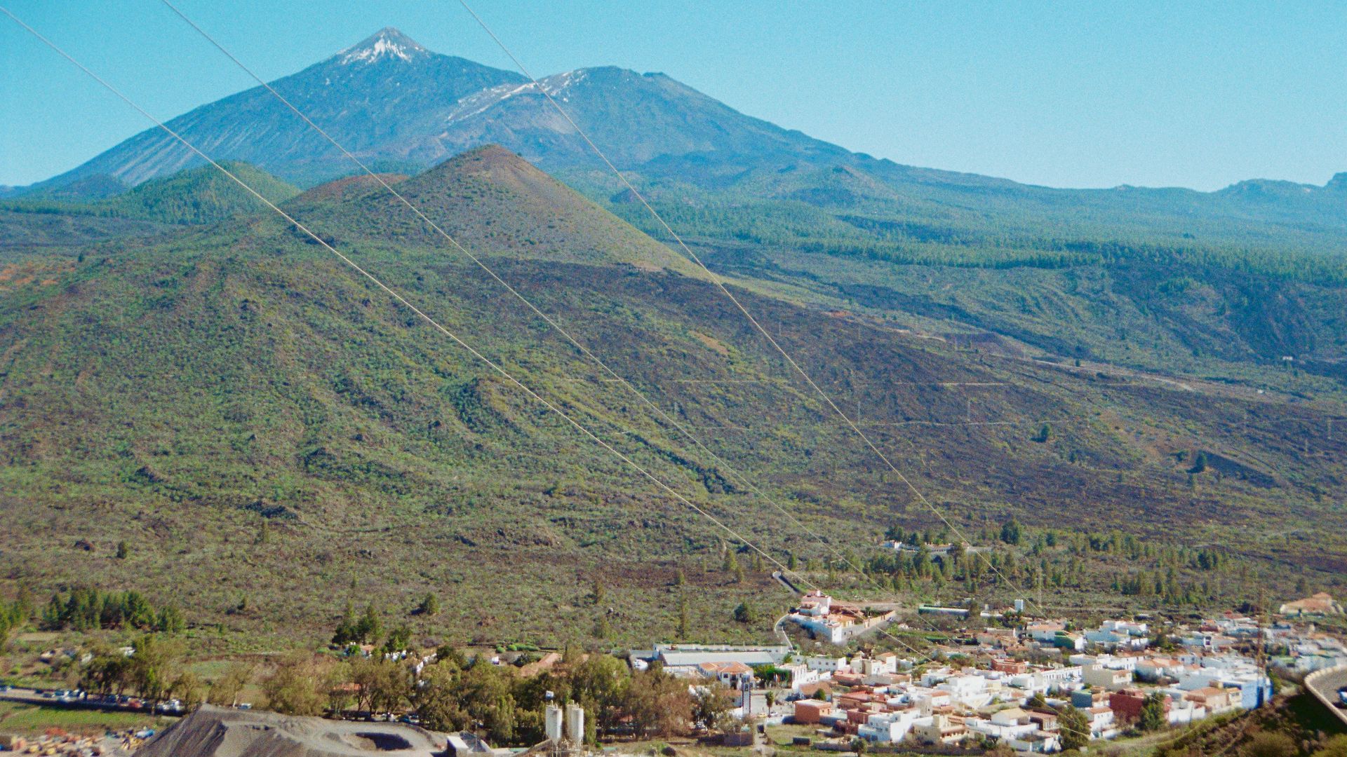 A majestic mountain overlooks a small town.