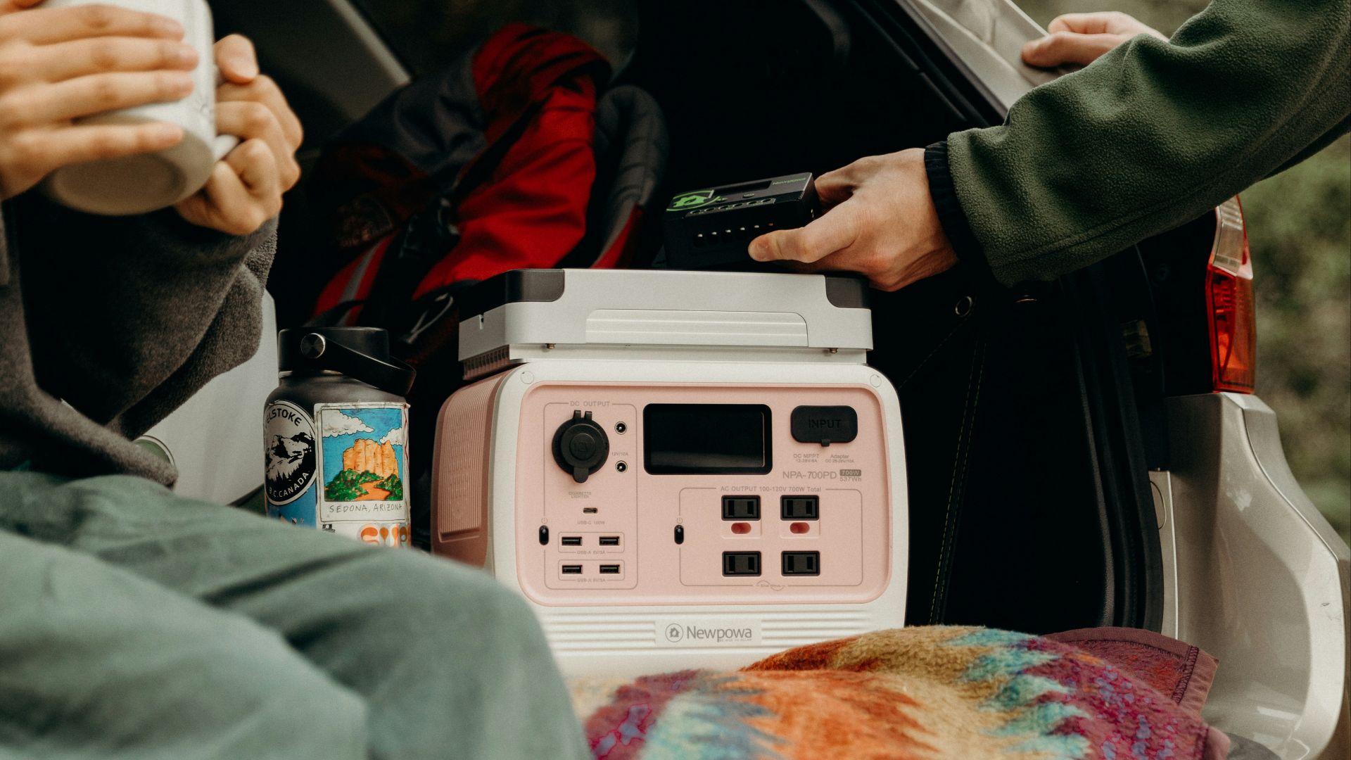 a woman sitting in the back of a car next to a man