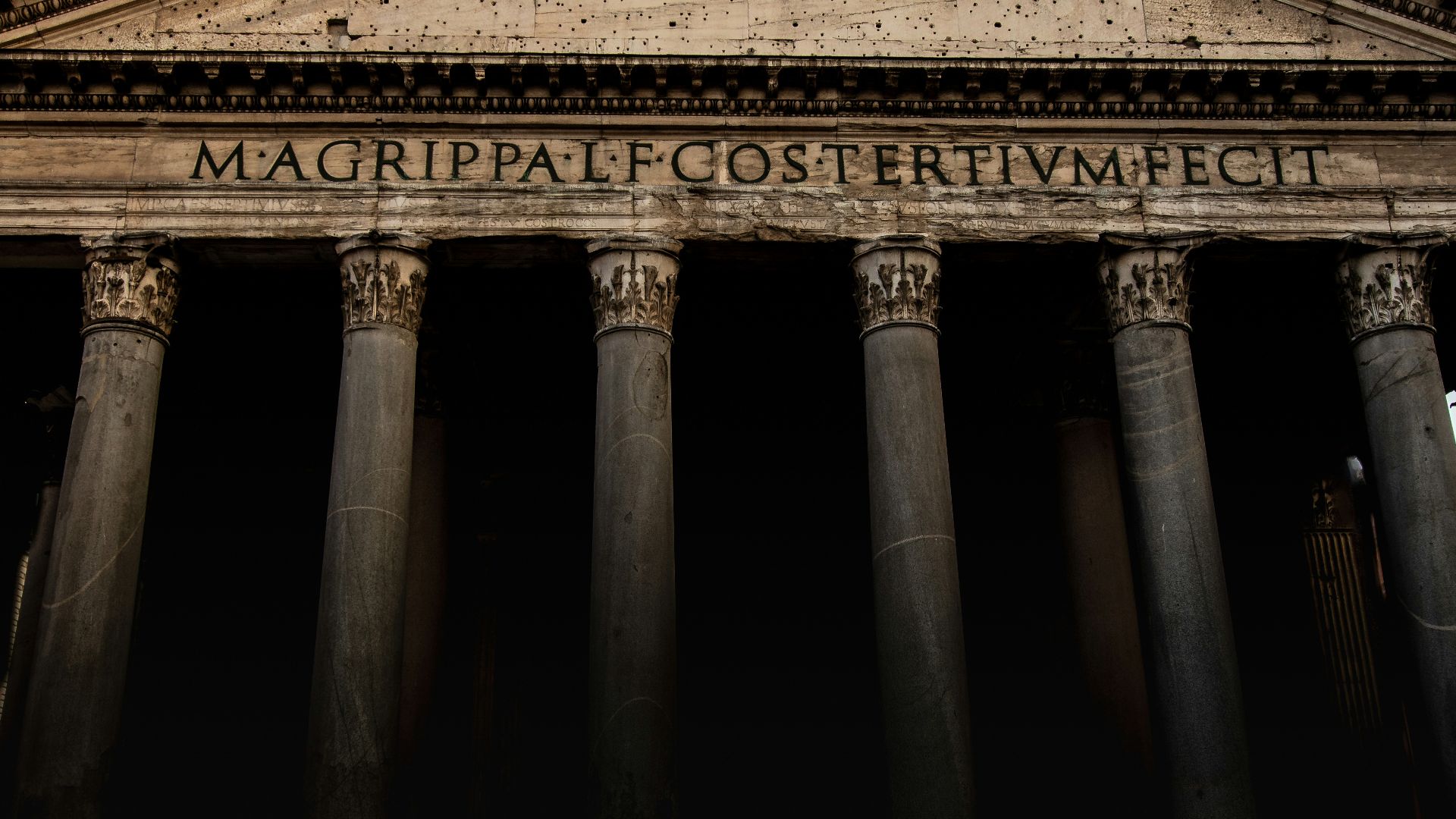 A tall building with columns and a clock