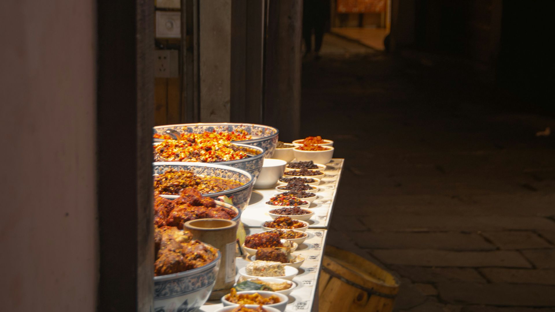 a long table with many bowls of food on it