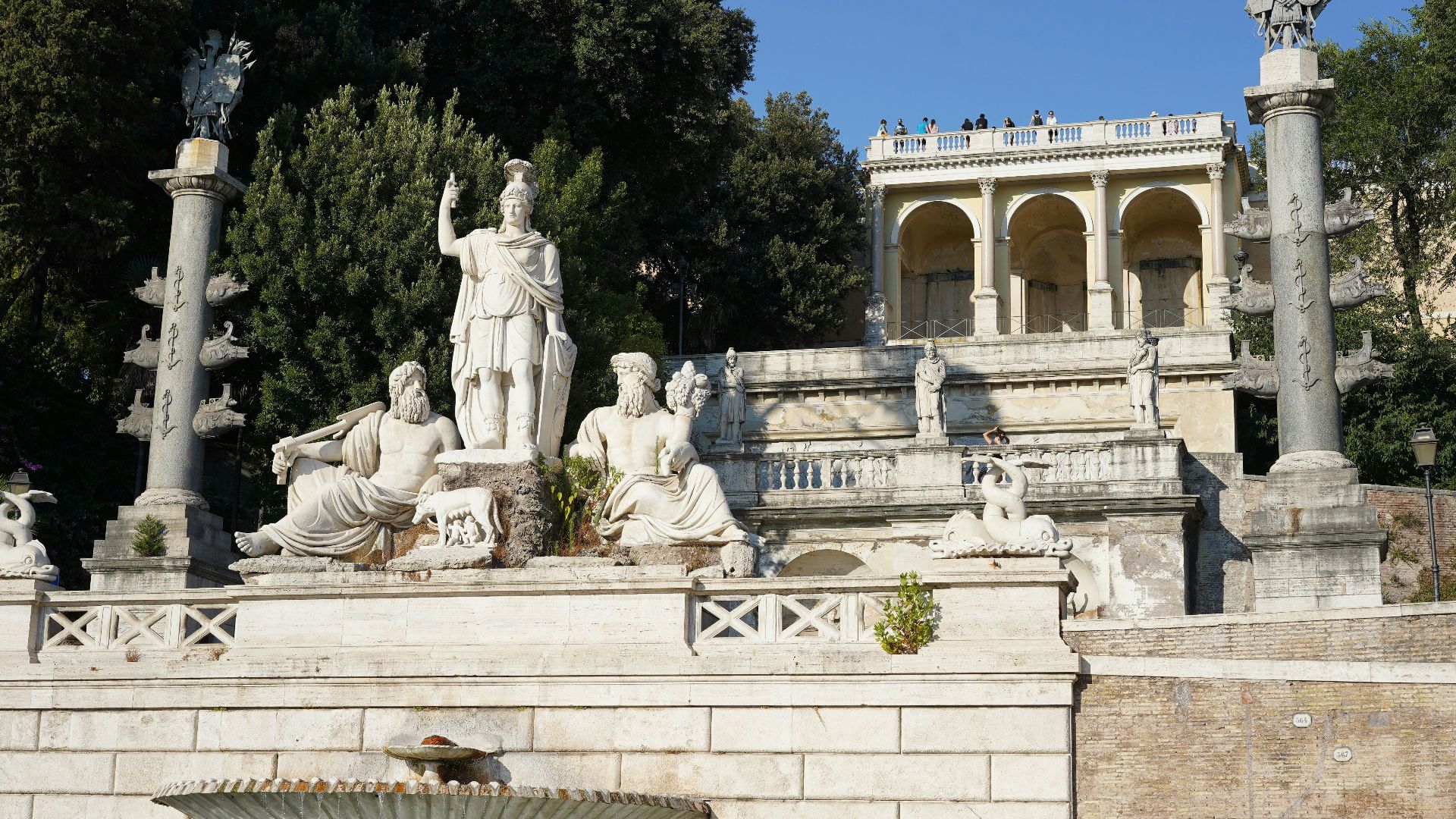a group of statues on a stone wall
