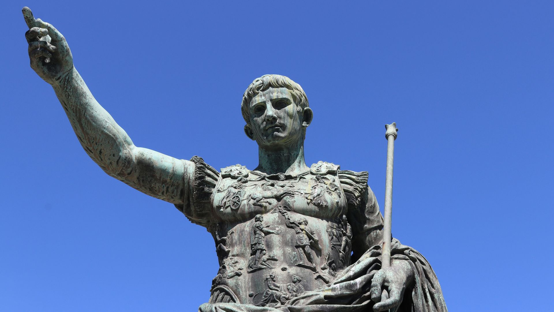 a statue of a person holding a staff