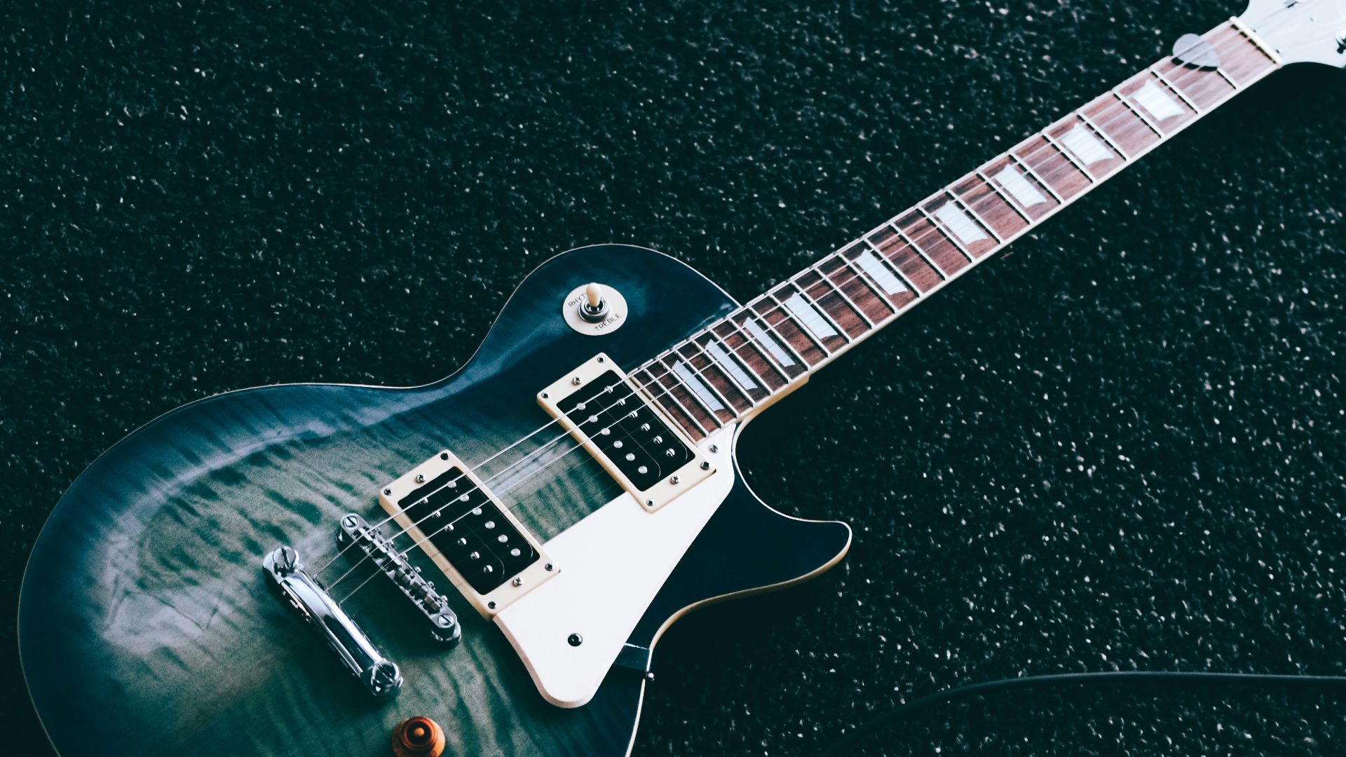 black whiskered single-cutaway electric guitar