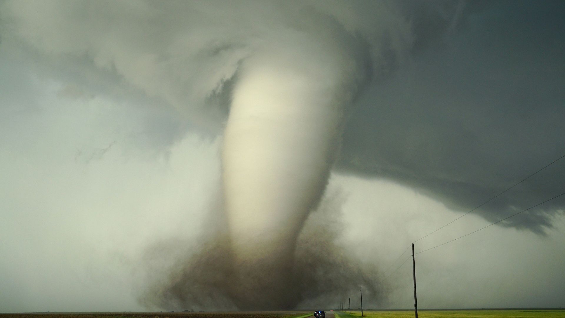 a large tornado is coming down the road