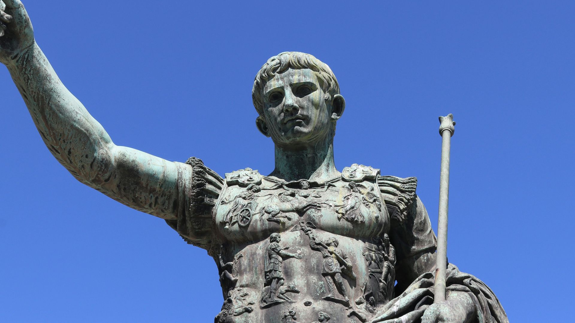 a statue of a person holding a staff