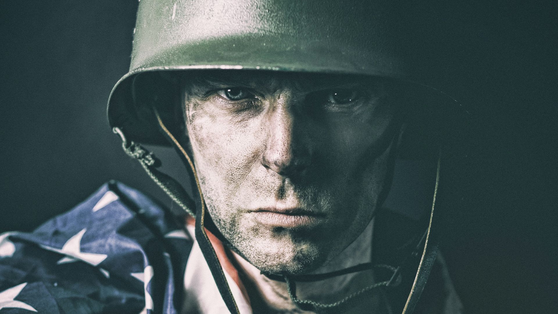 man in black hat and green jacket