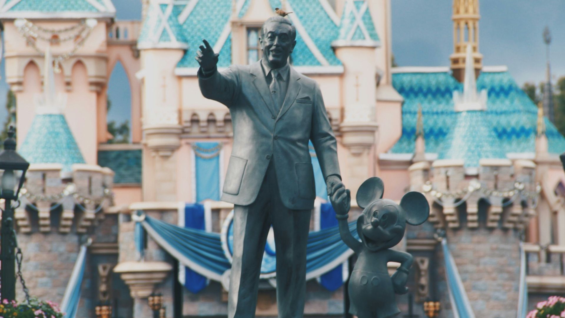 man holding rat concrete statue