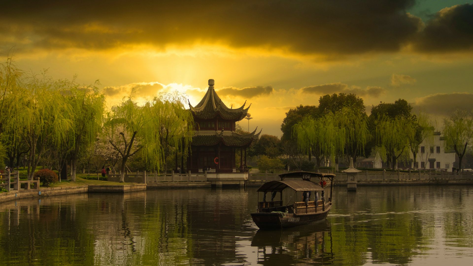 brown wooden house on lake during sunset