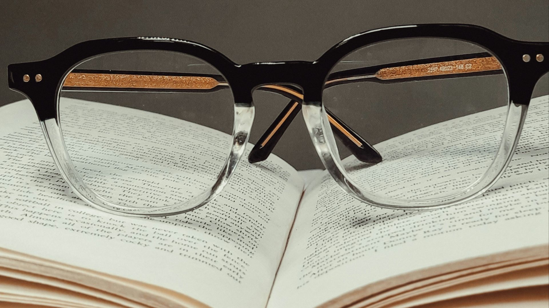 black framed eyeglasses on book page