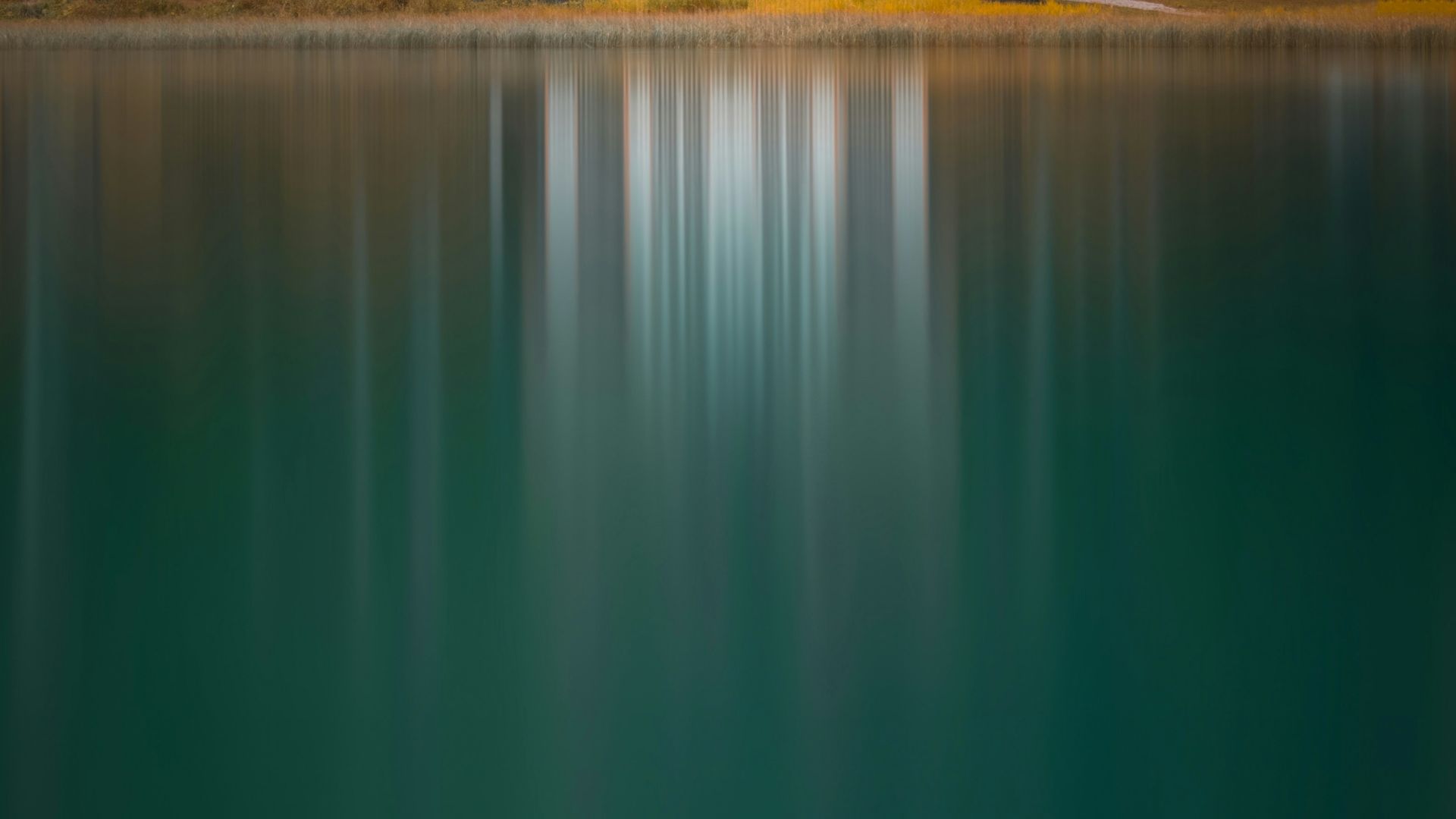 white and brown house near lake and green trees during daytime