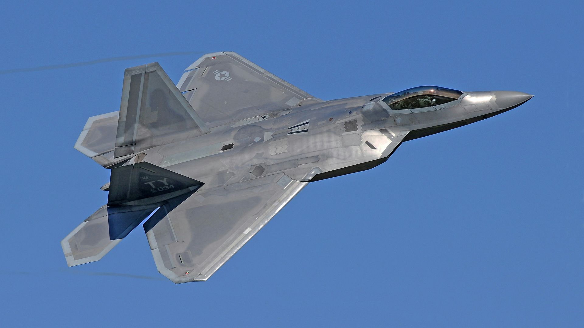 flying gray jet plane