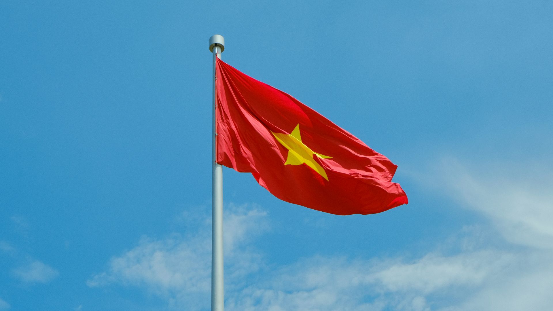 A chinese flag flying high in the sky