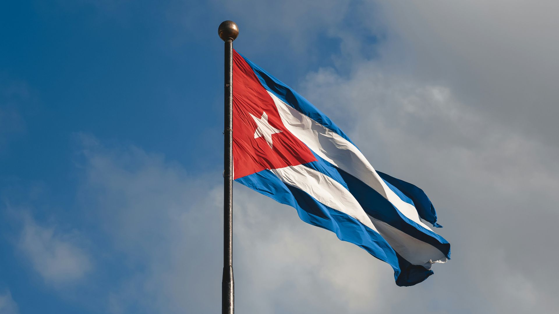 a flag flying in the wind on a cloudy day