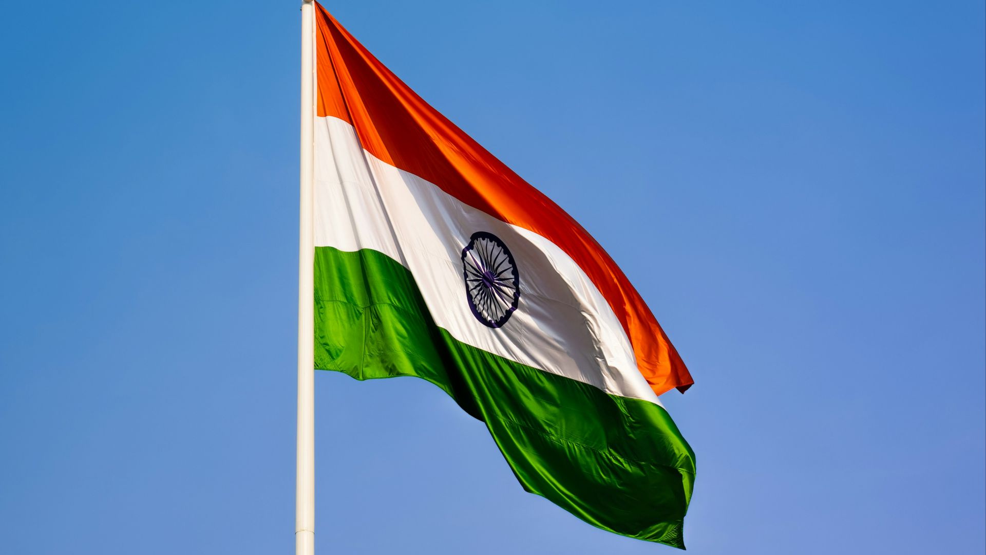 the indian flag is flying high in the blue sky