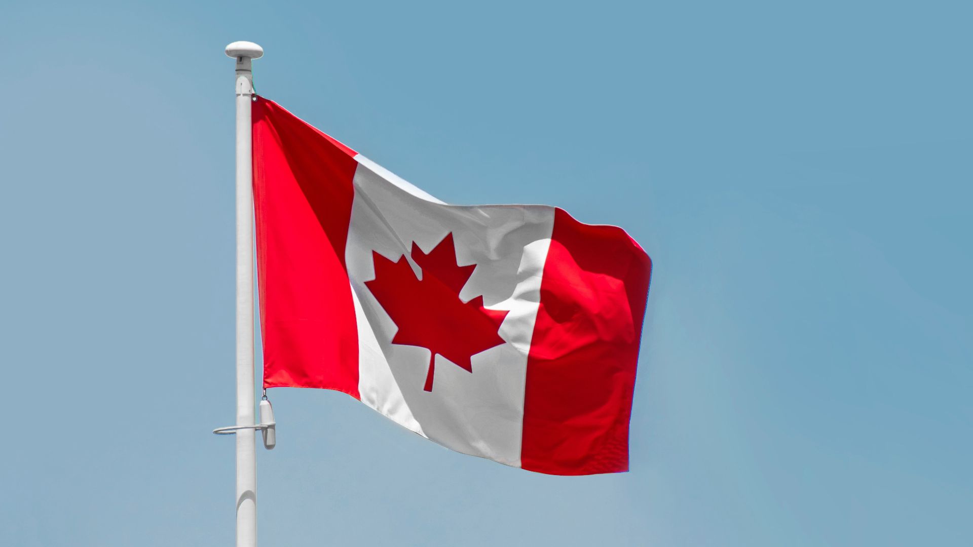 a red and white flag on a flagpole