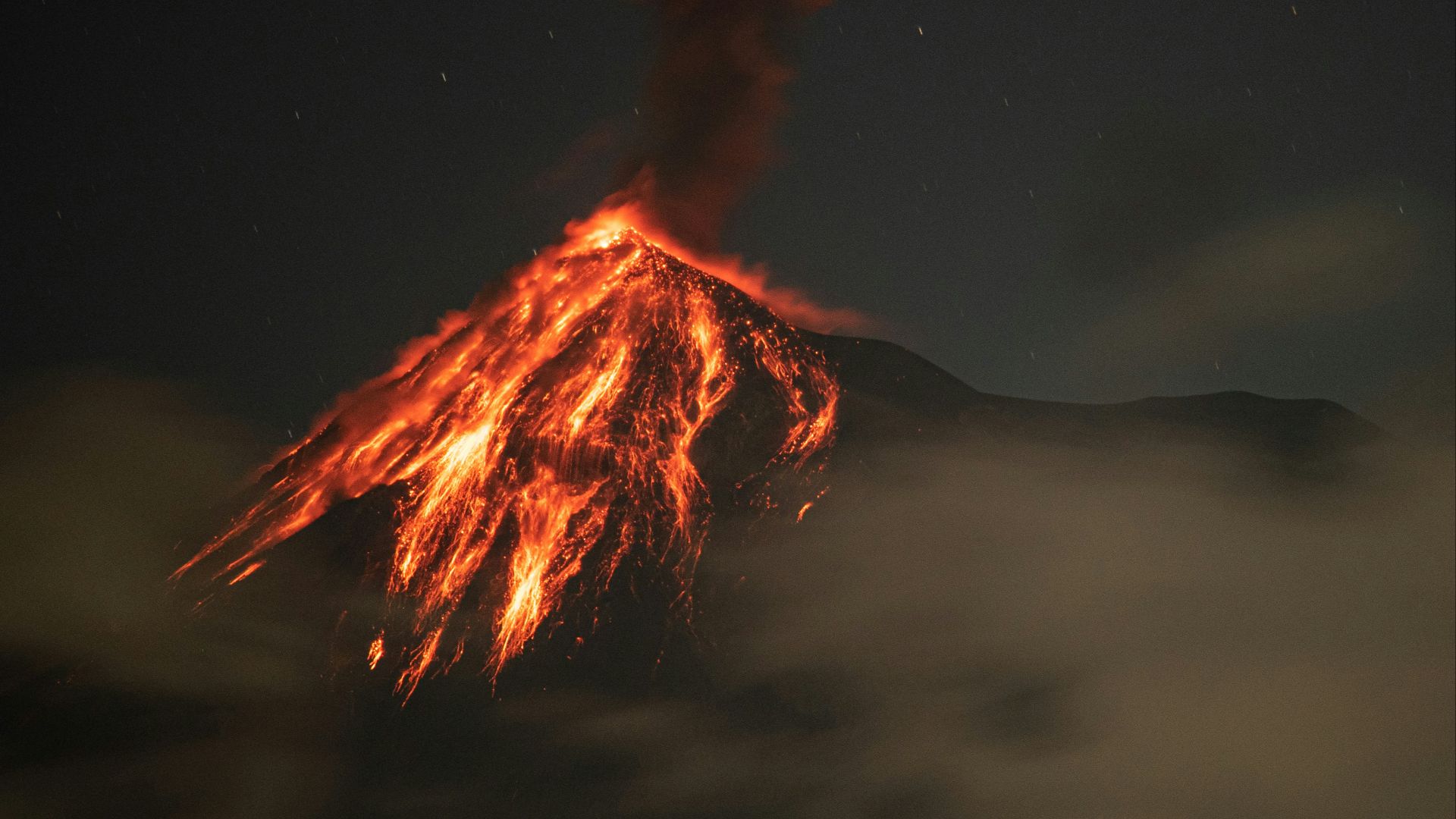 a volcano spewing lava into the night sky