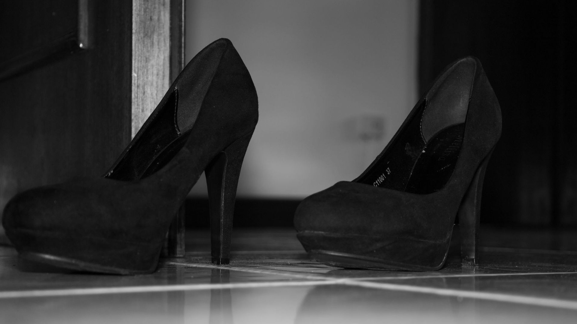 A pair of high heeled shoes sitting on the floor