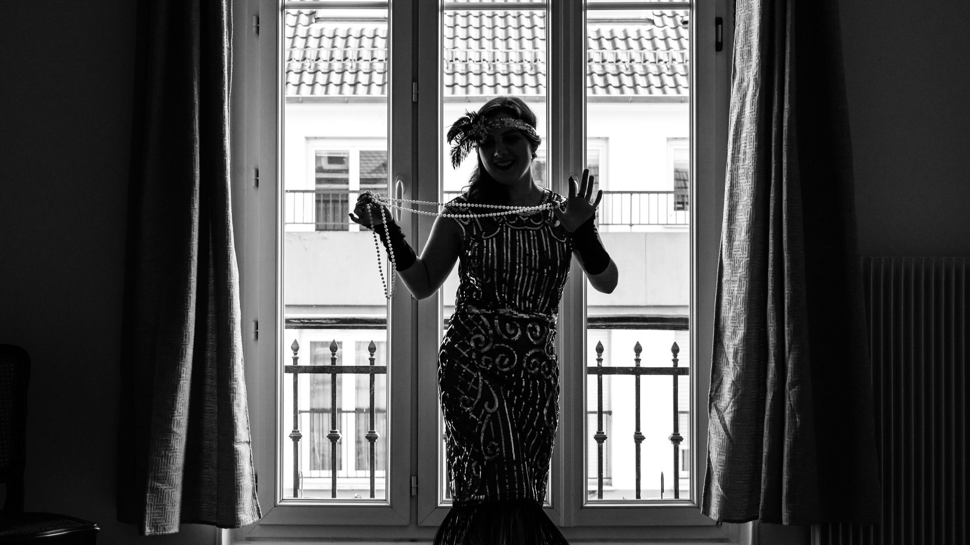 a person in a dress dancing in a room with a large window