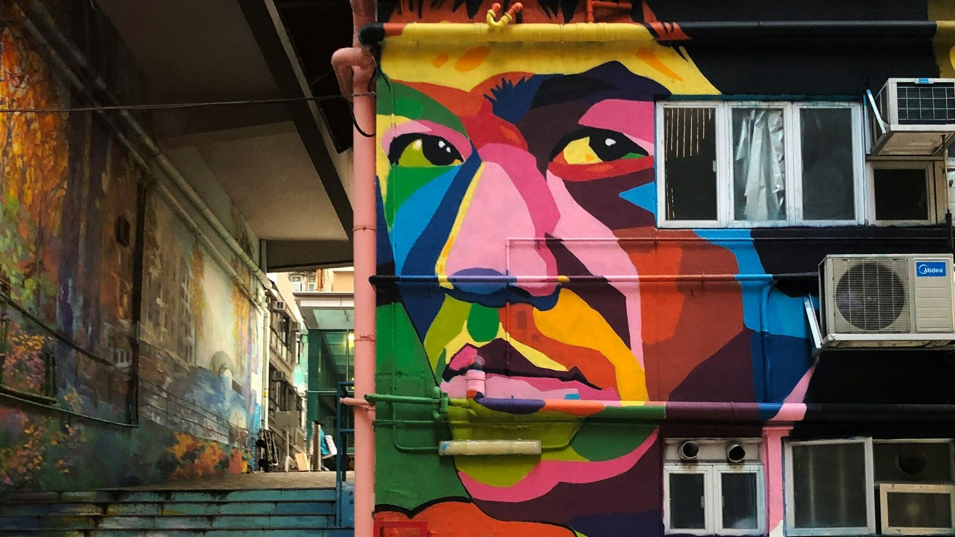 blue and pink graffiti on wall