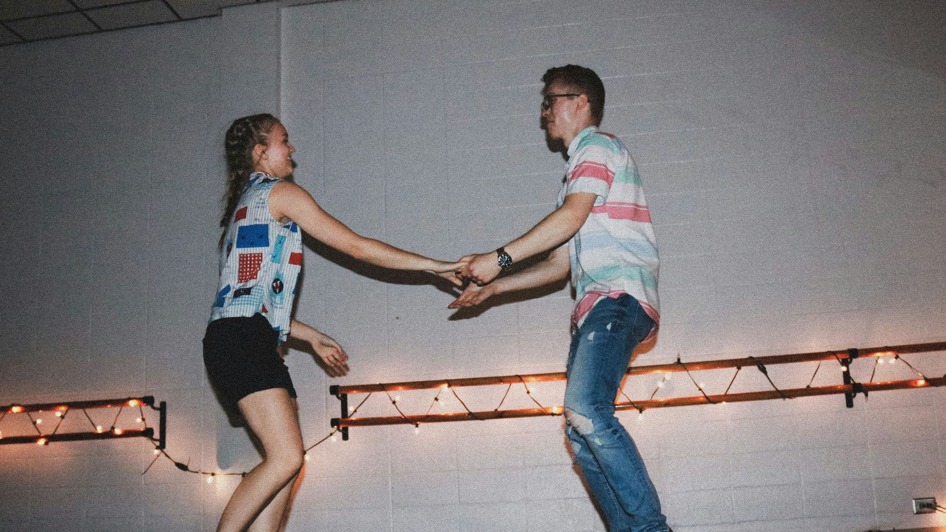woman and man standing near wall