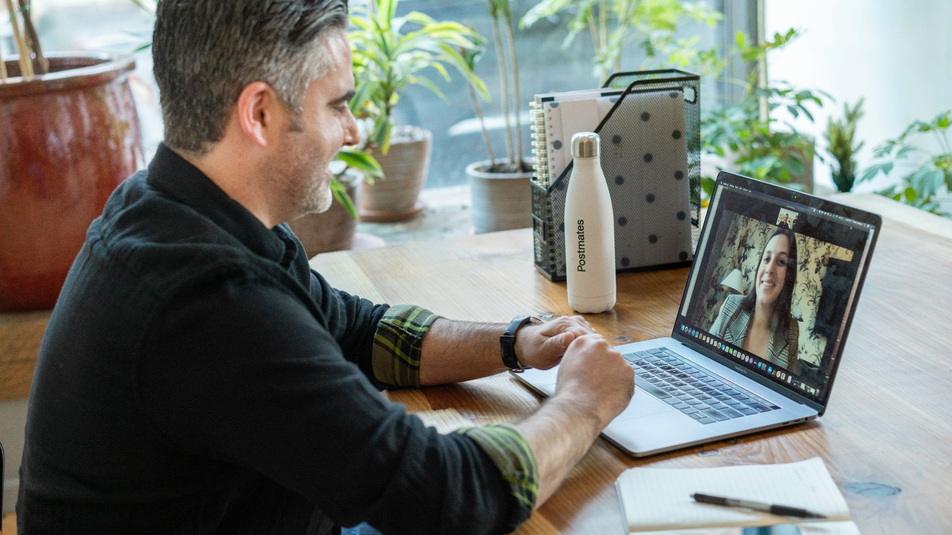 man in black sweater using macbook pro