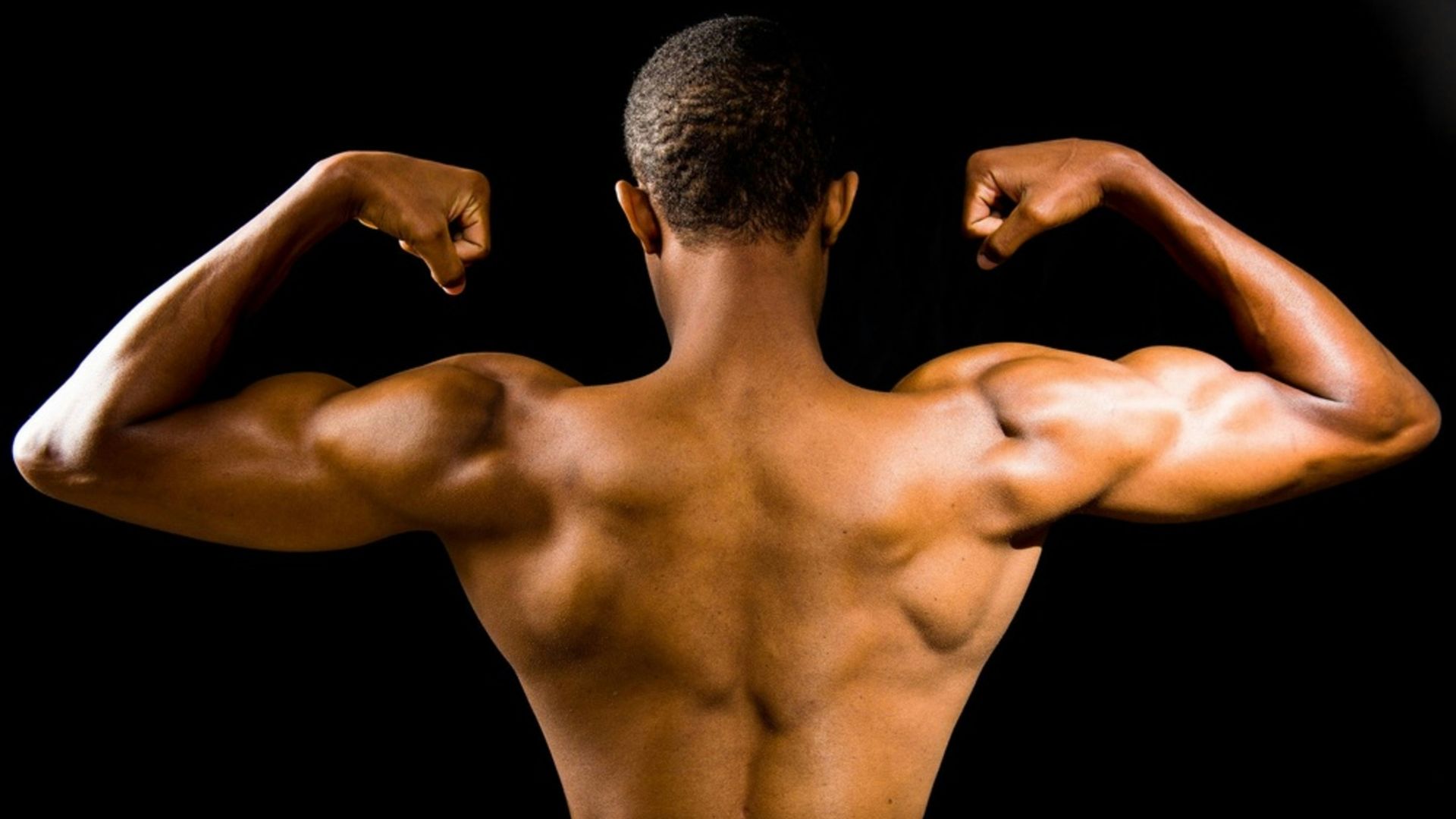 topless man with black background