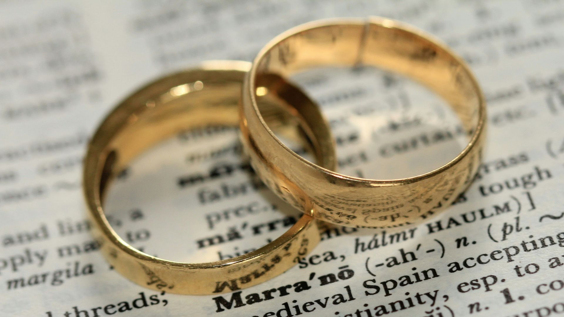 two gold-colored rings on paper