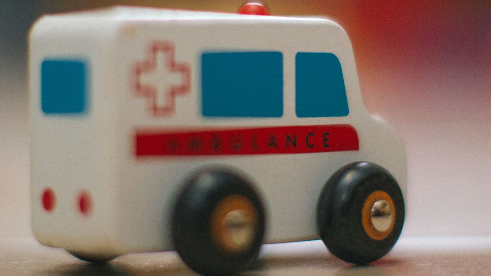 a toy ambulance is sitting on the floor