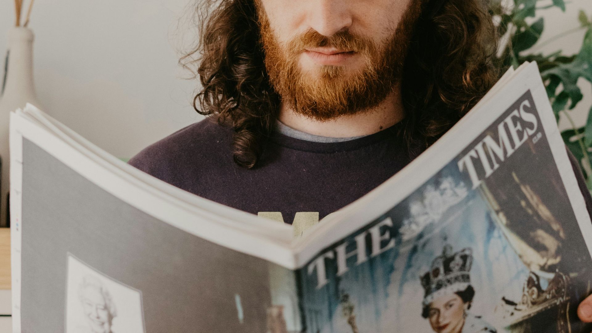 a person wearing a hat and holding a book