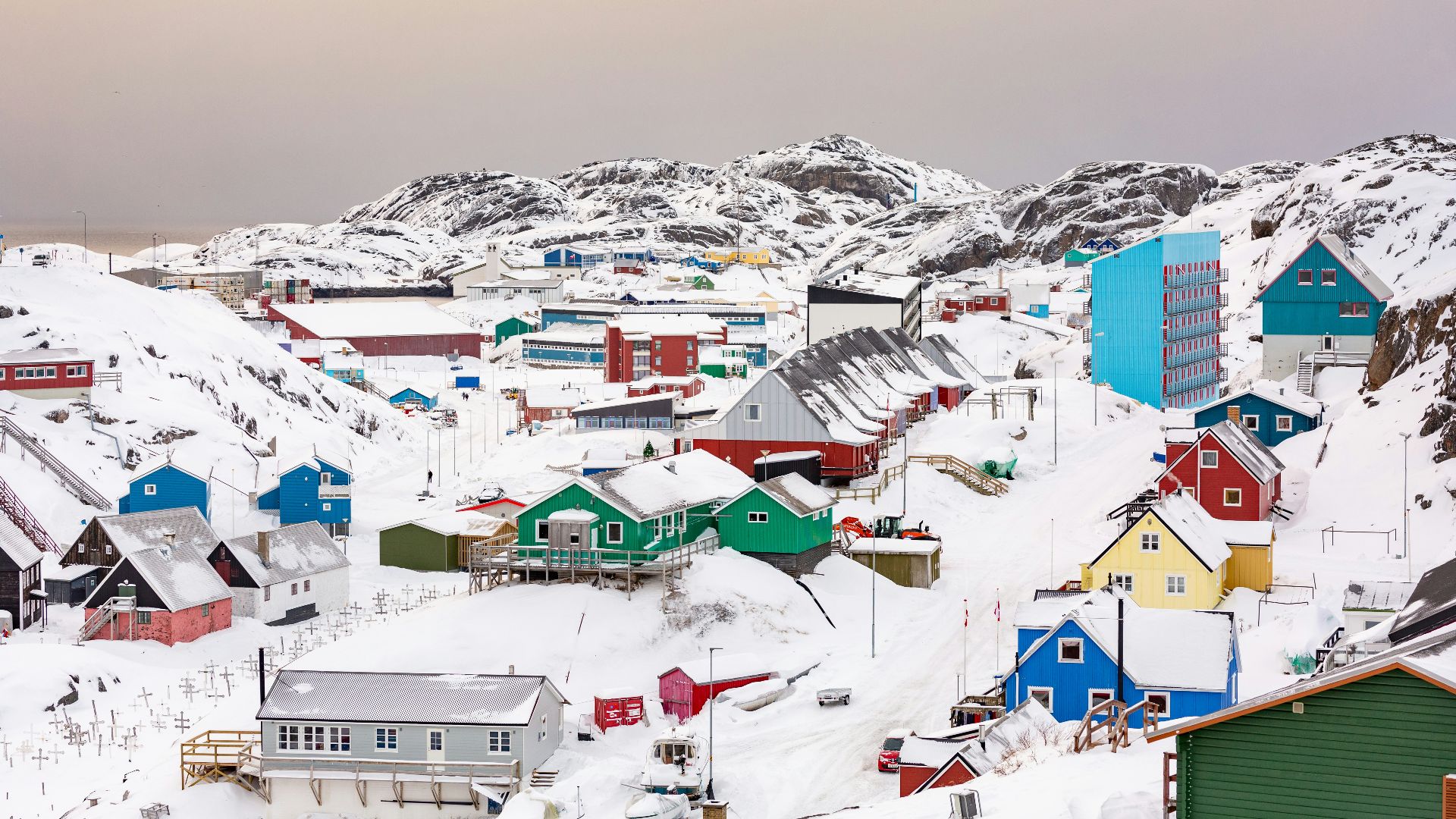 town on hill covered with snow
