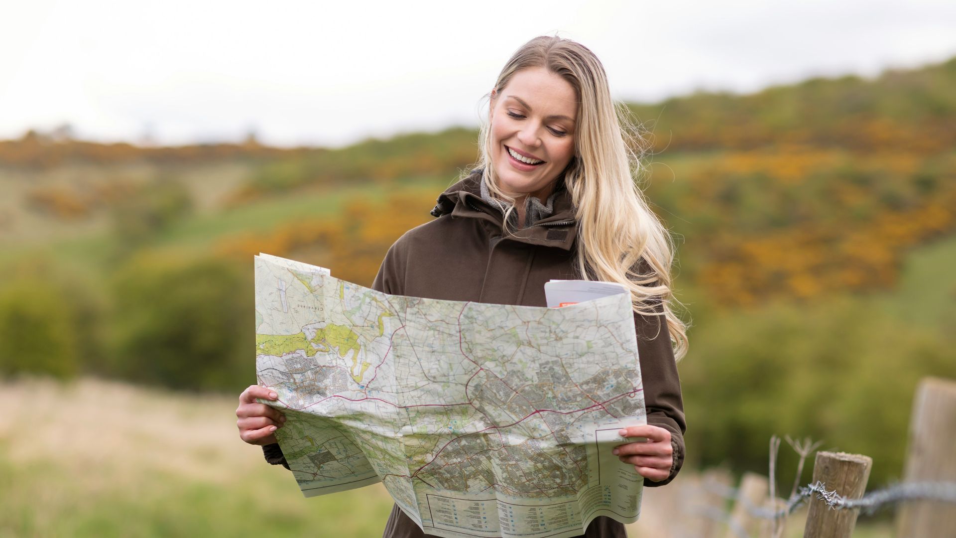 a woman holding a map in her hands