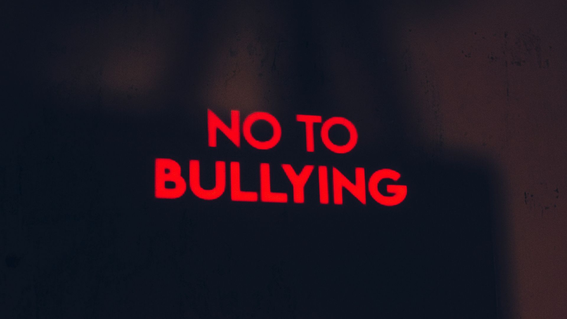 a red sign that says no to bullying