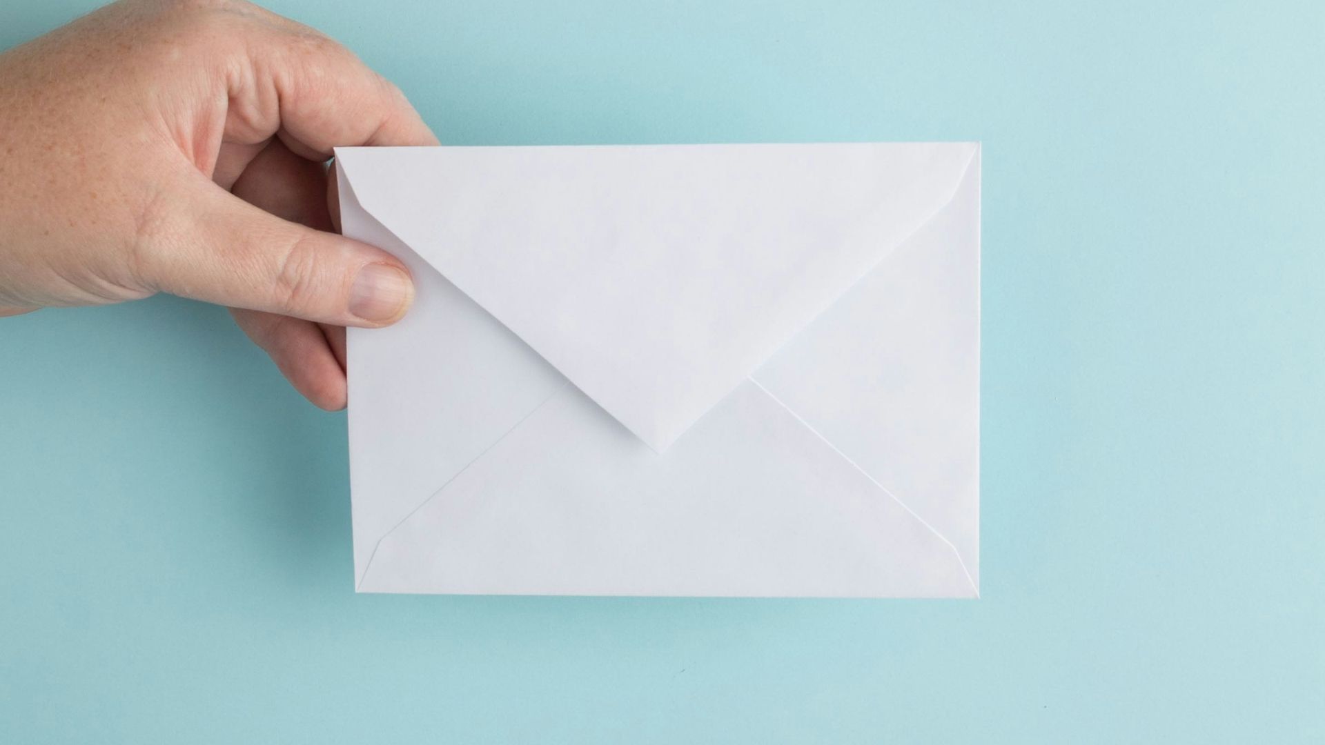 person showing white envelope