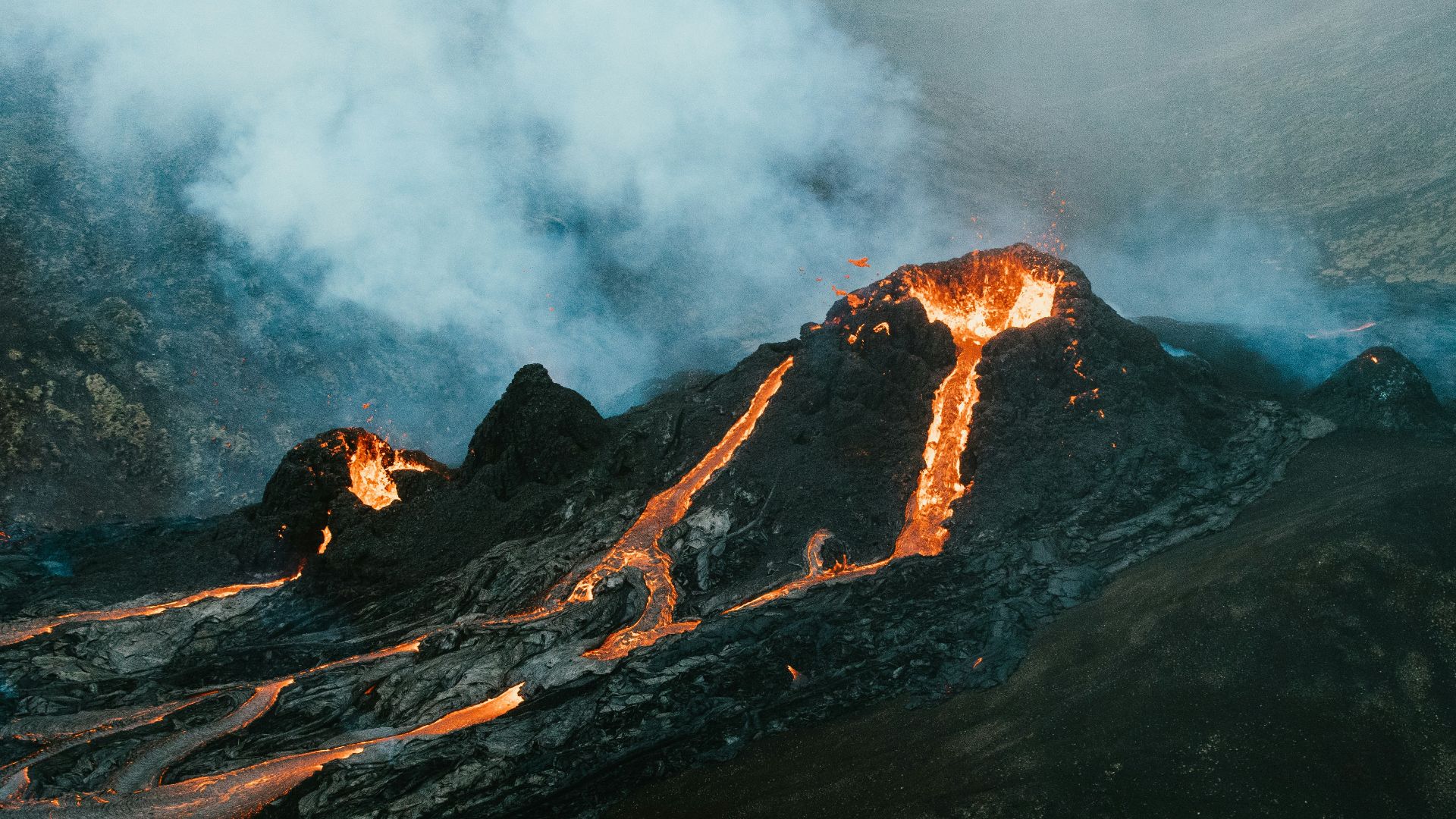 brown and black mountain with white clouds