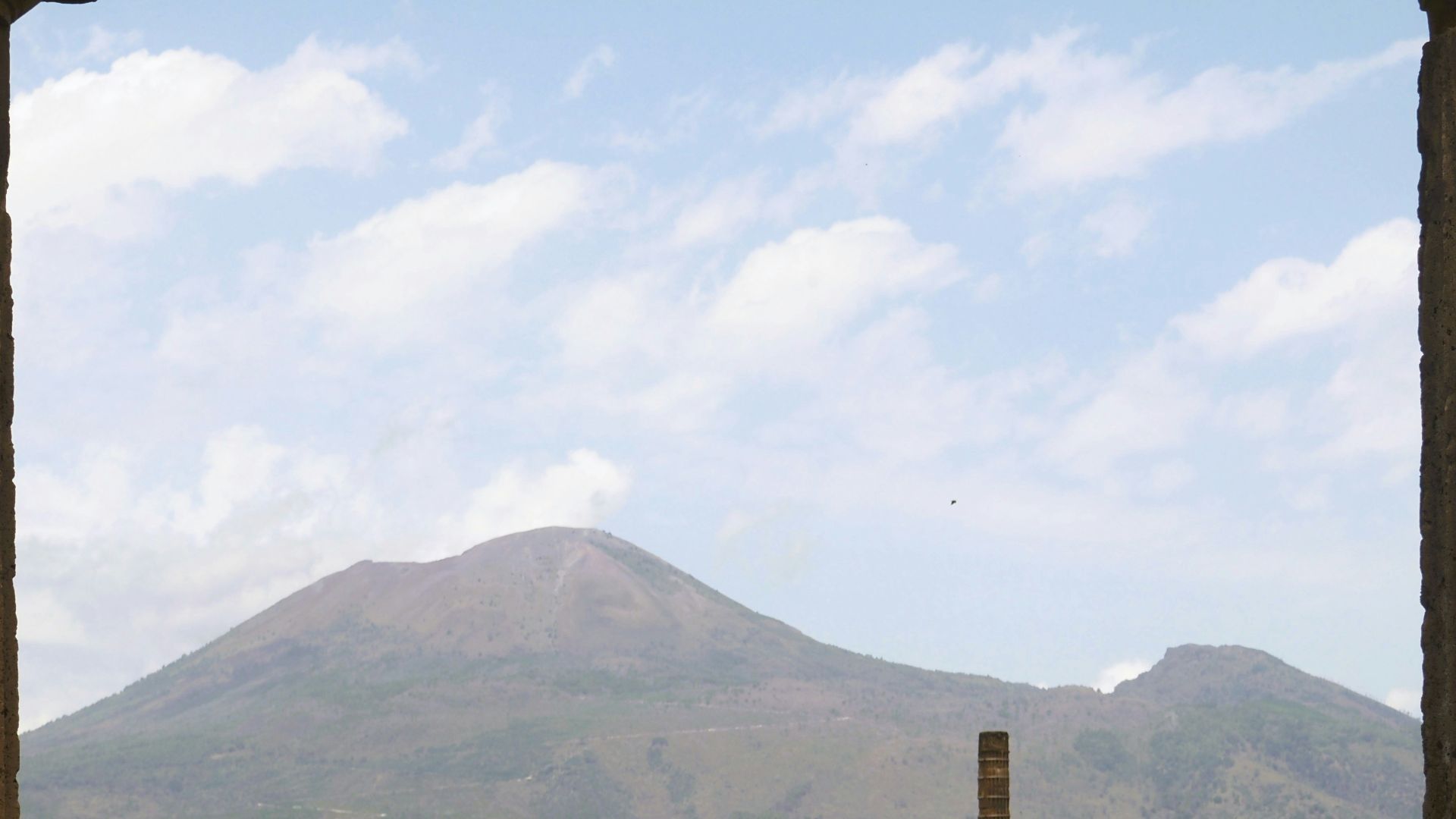 an old building with a mountain in the background