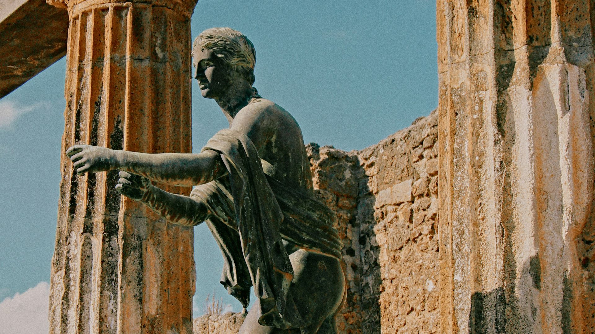 a statue of a man standing next to a building