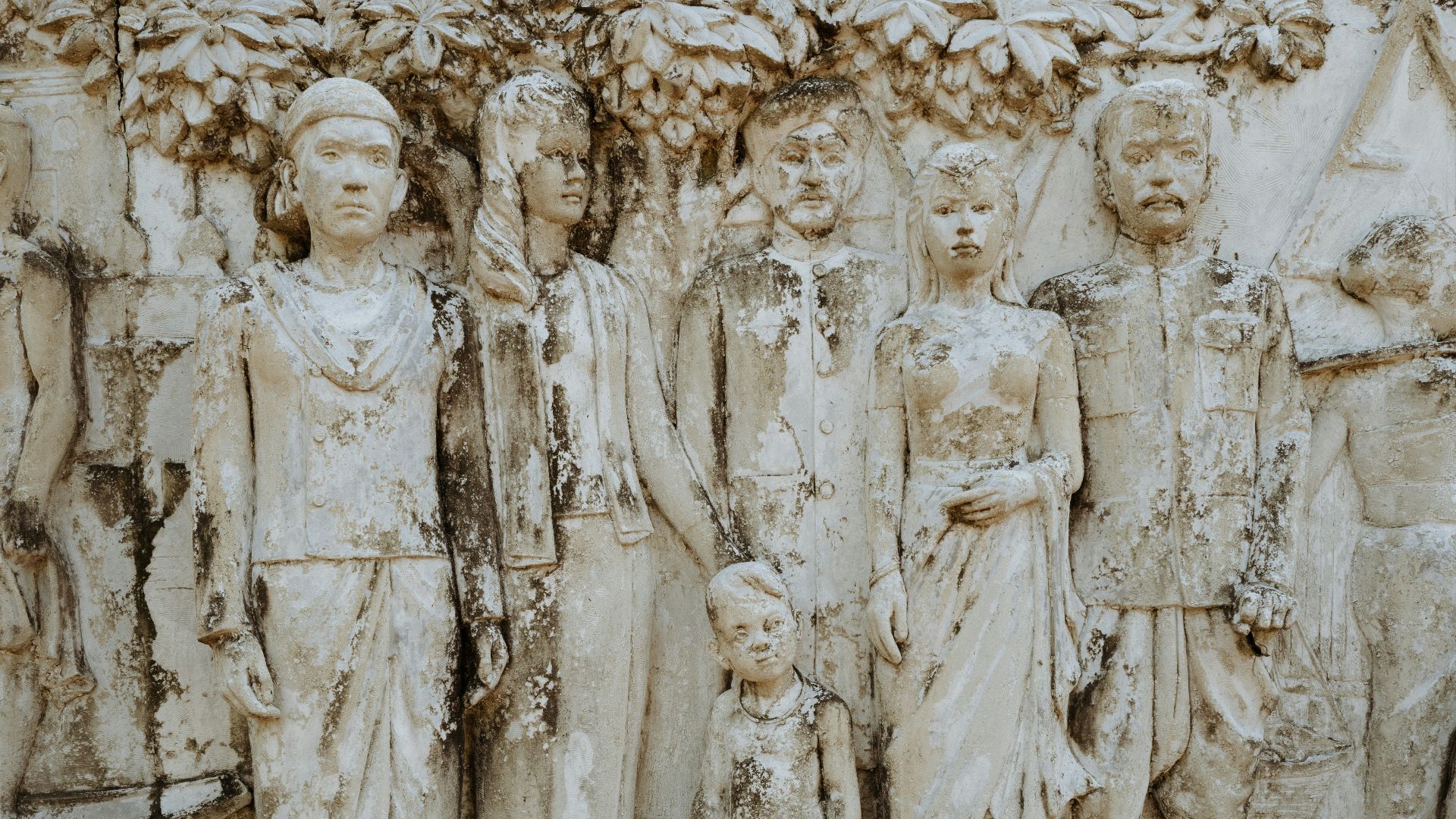Relief sculpture of people standing together.