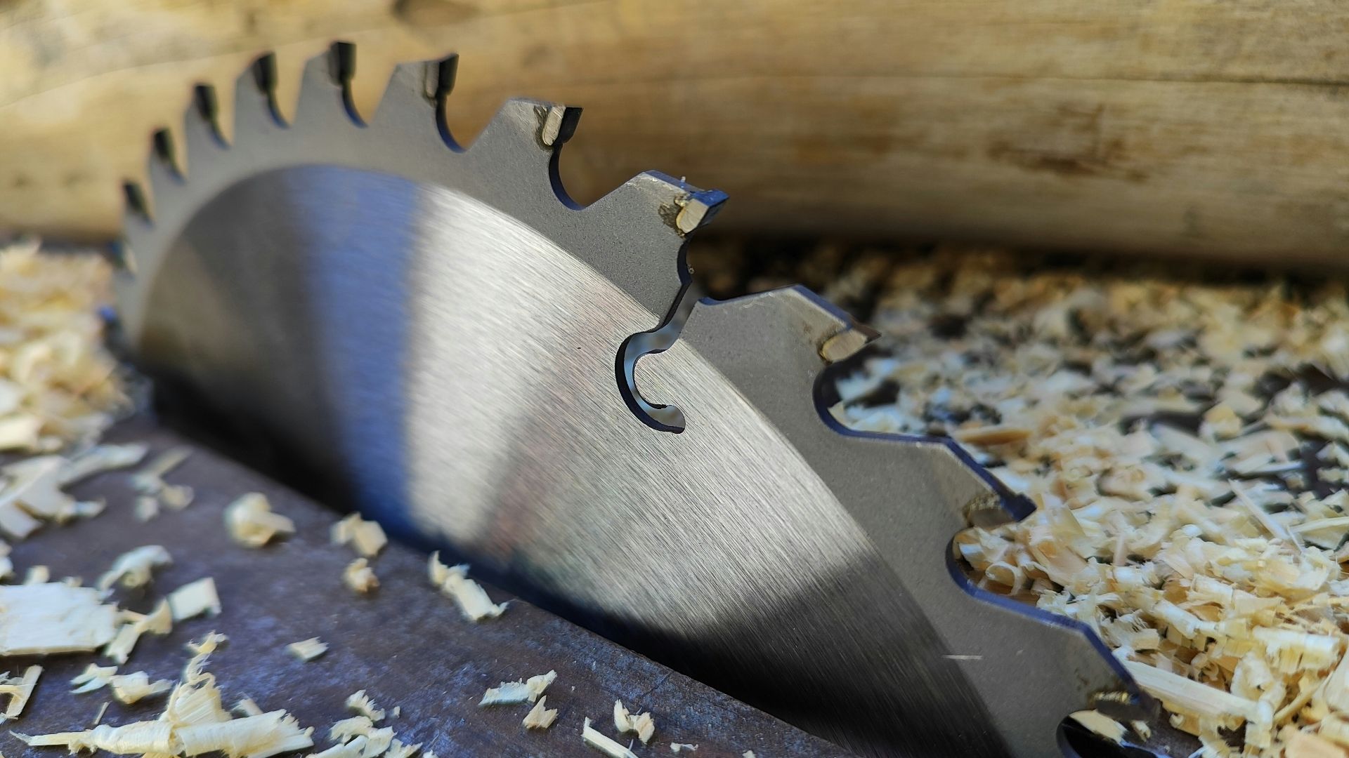 a close up of a metal blade on a piece of wood