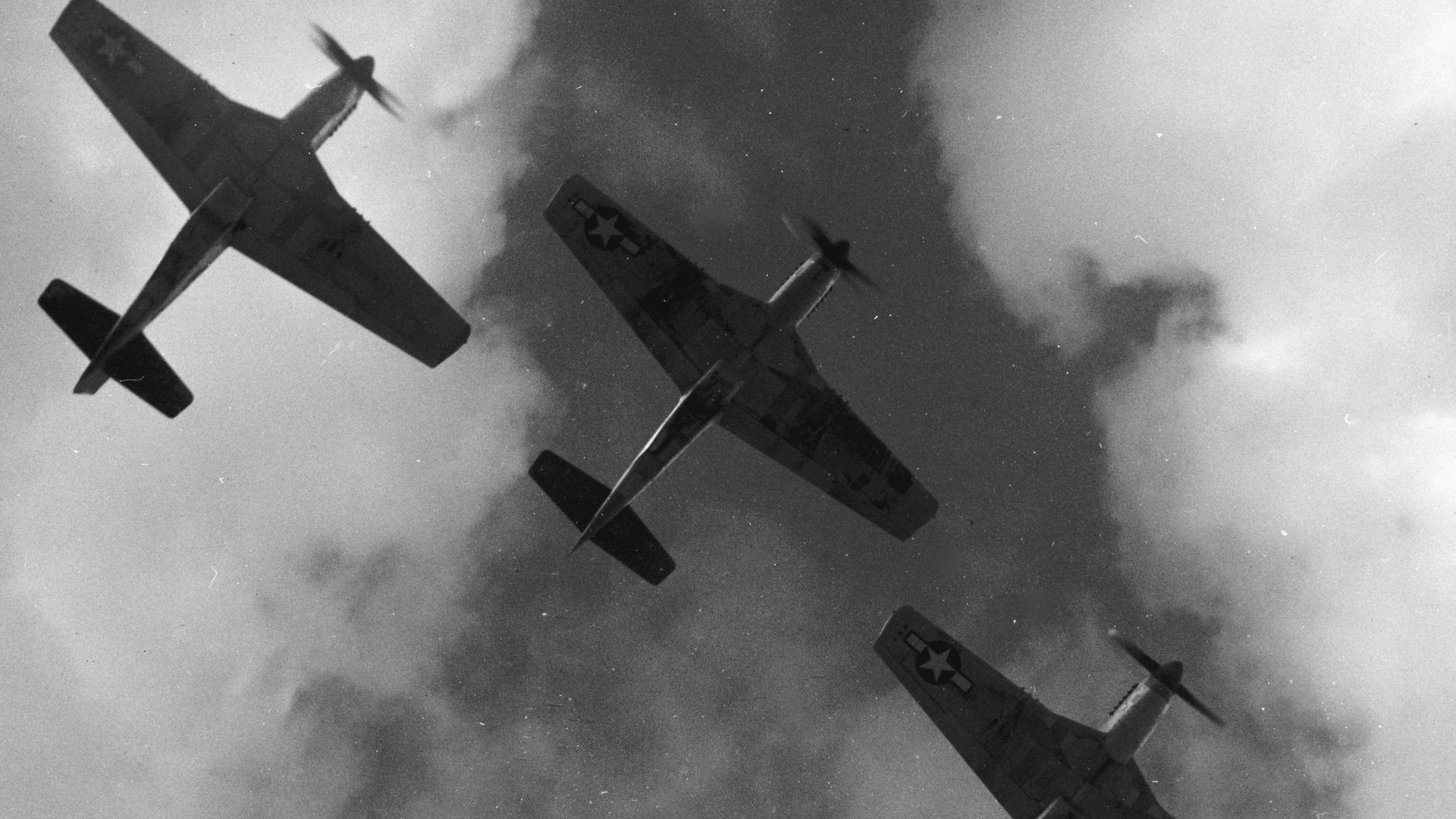Four P-51 Mustangs flying in formation