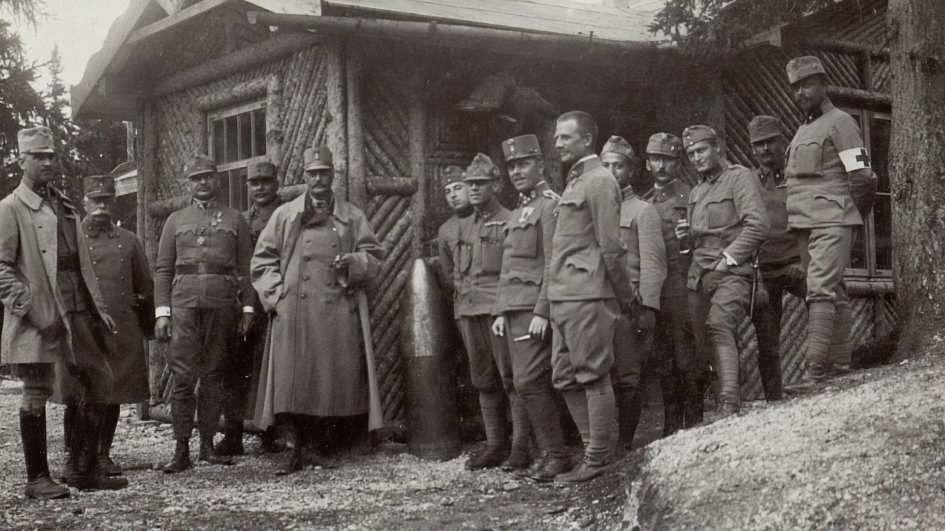 grayscale photography of soldier standing beside house during daytime