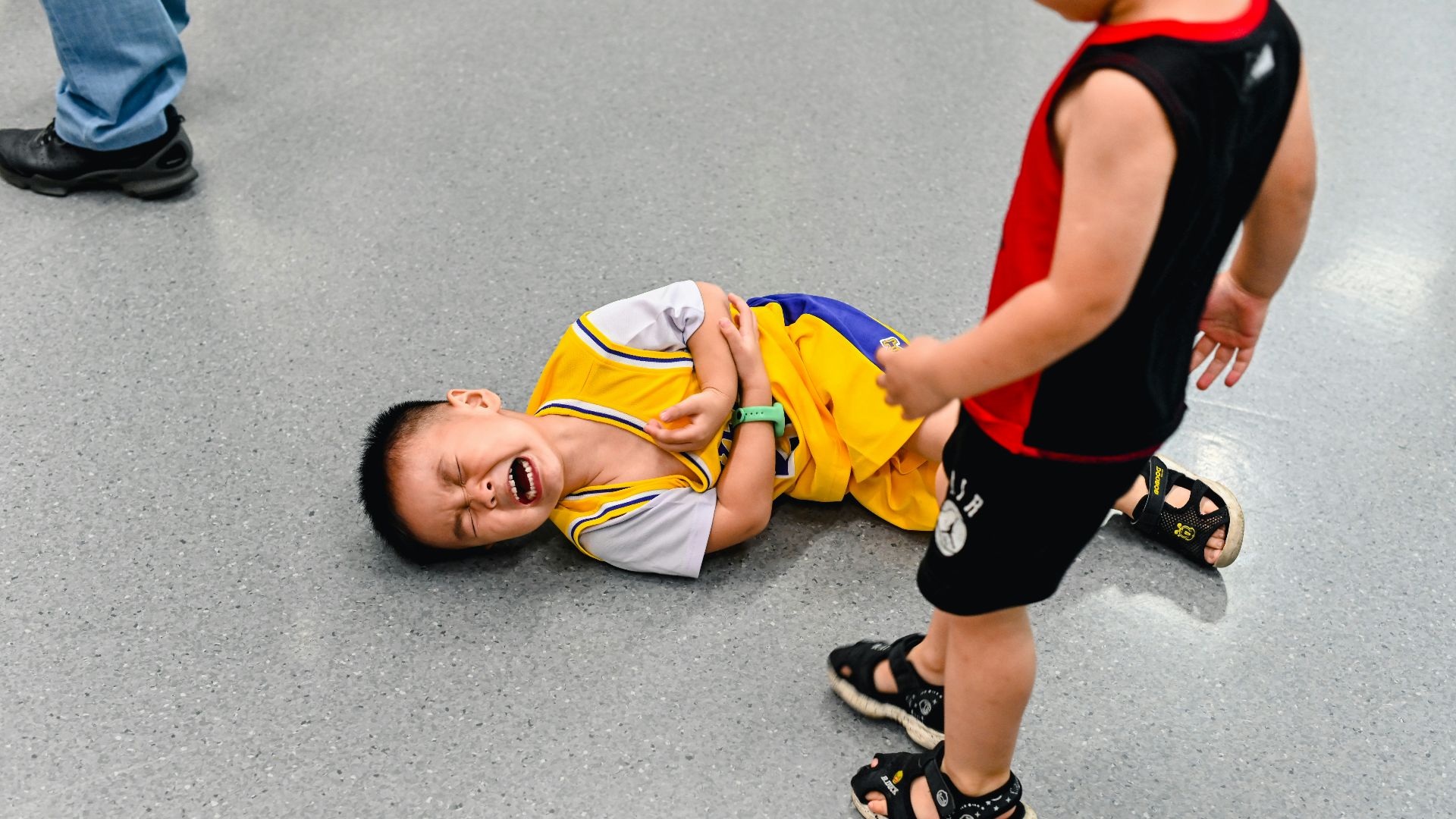 2 boys lying on the ground
